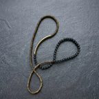 Copper and lava bead strand laid out at full length to show the necklace option