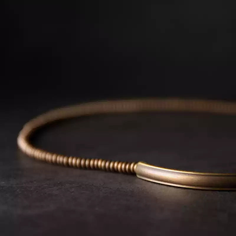 Close-up of the curved copper tube bar and copper heishi beads