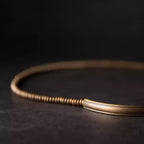 Close-up of the curved copper tube bar and copper heishi beads