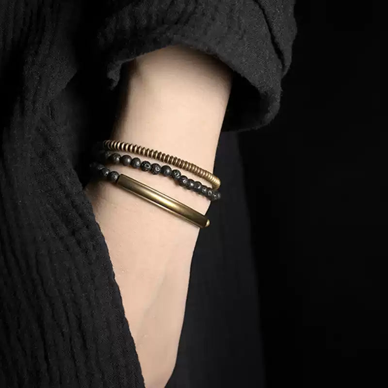 Copper and lava bead strand worn as a triple wrap bracelet on the wrist