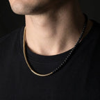 Man wearing the copper and black lava bead necklace with a black t-shirt