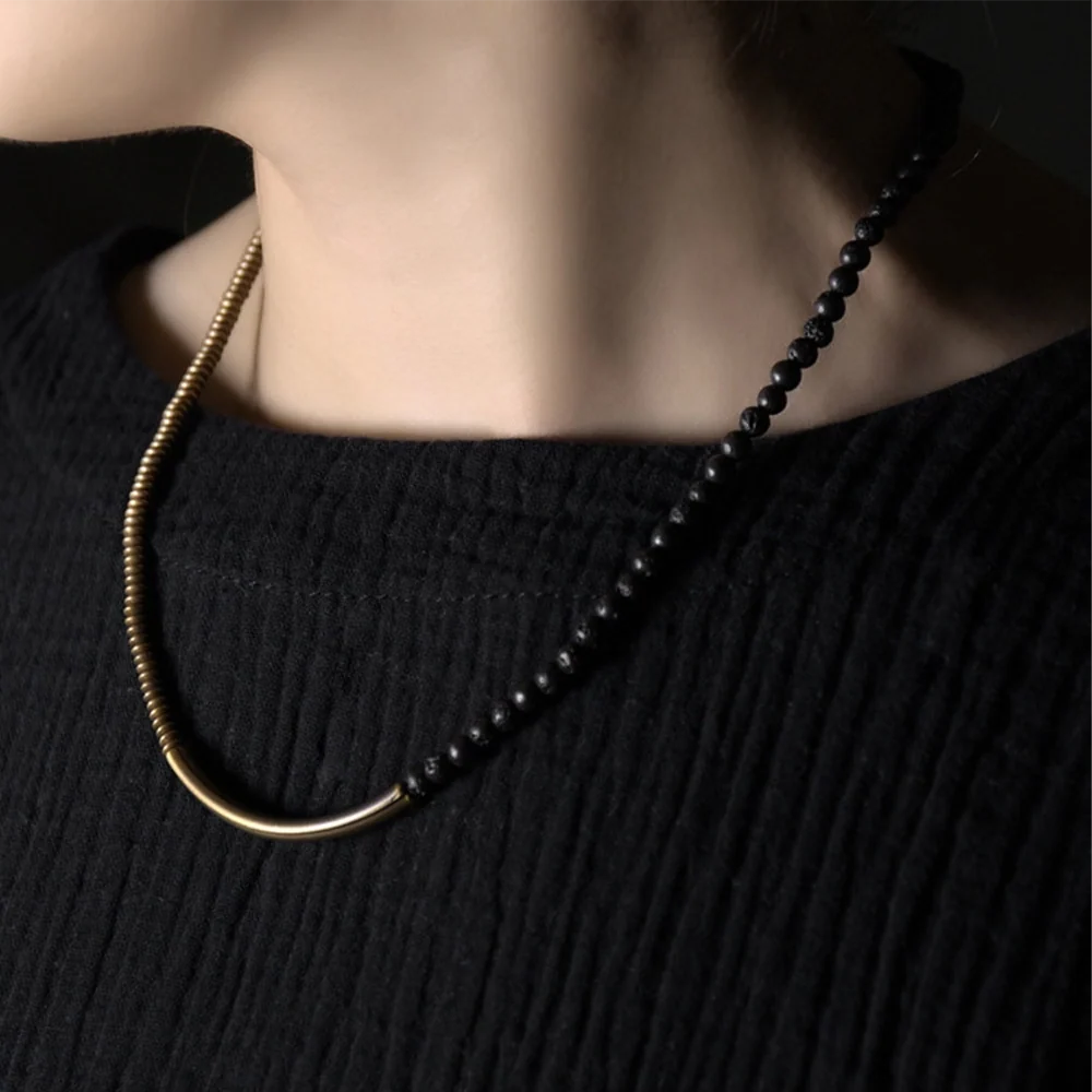 Woman wearing the copper and black lava bead strand as a necklace with a black top