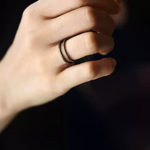 Double band copper ring worn on the middle finger