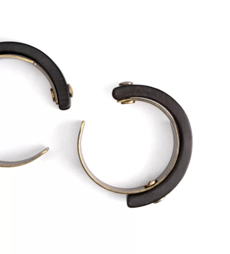 Two-piece construction of the copper and ebony cuff: ebony wood arc and copper band shown apart