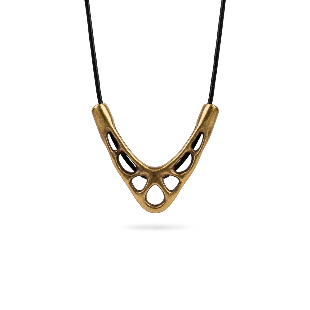 Sculptural V-shaped openwork copper pendant on a black cord necklace, white background
