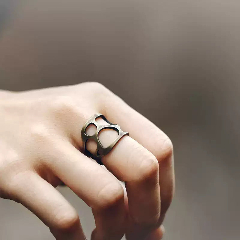Openwork copper ring worn on the index finger