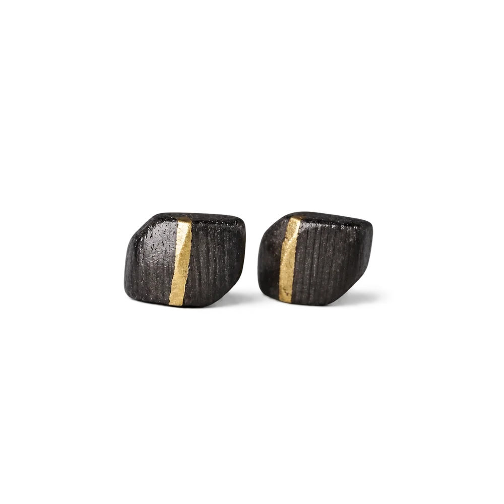 Pair of square ebony wood stud earrings with a vertical copper inlay stripe, white background