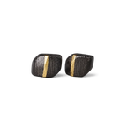 Pair of square ebony wood stud earrings with a vertical copper inlay stripe, white background