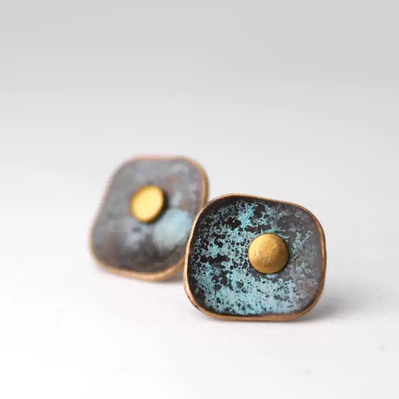Close-up of the verdigris patina texture on square copper earrings