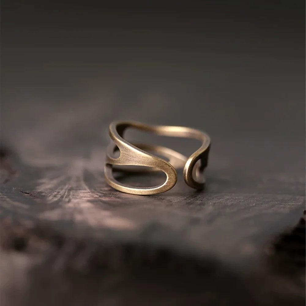Angled view of the open adjustable wavy copper ring
