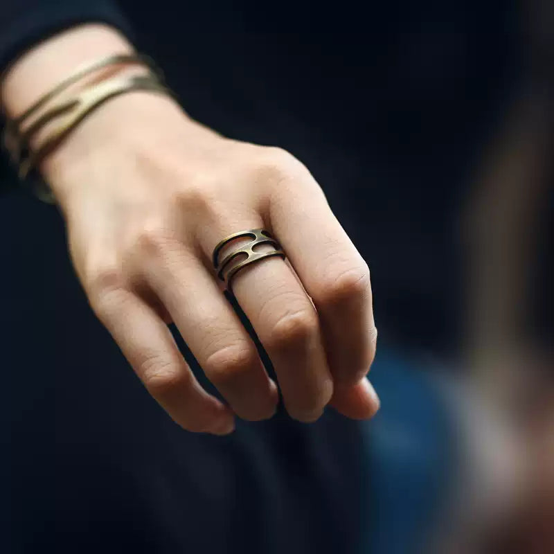 Wavy copper ring worn on the ring finger with a copper wire cuff on the wrist