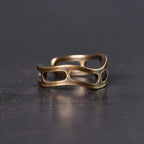 Side view of the wavy copper ring with oval cutouts