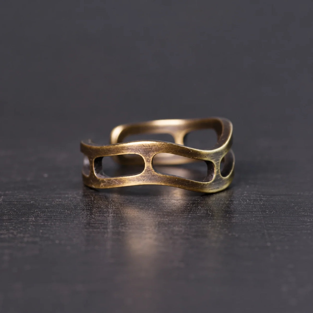 Side view of the wavy copper ring with oval cutouts
