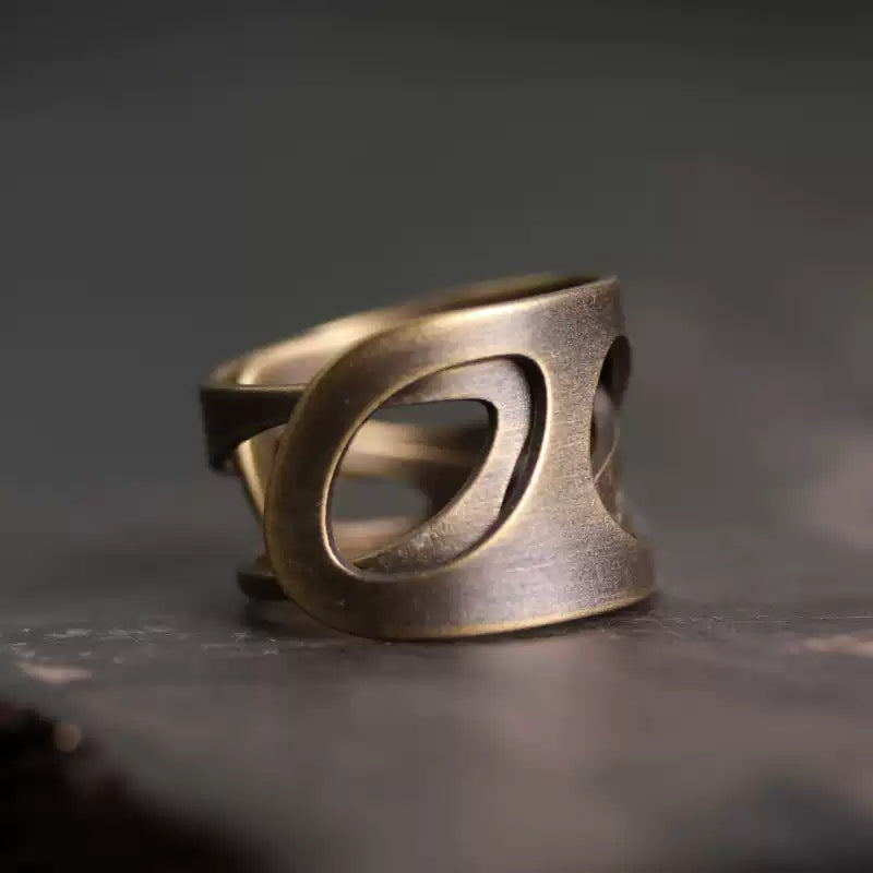 Wide cutout copper ring on dark stone