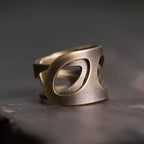 Wide cutout copper ring on dark stone