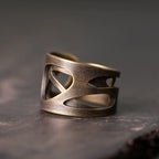 Side view of the wide copper ring showing its layered cutout bands