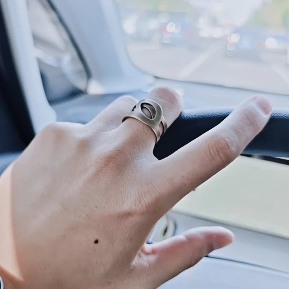 Wide cutout copper ring worn on the index finger