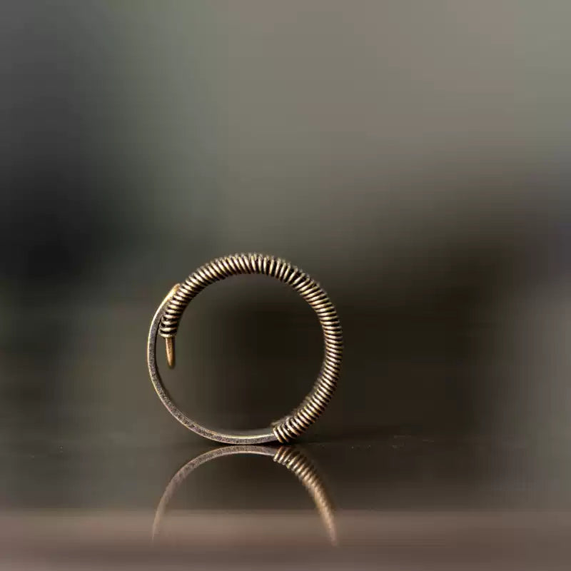 Profile of the wire-wrapped copper ring showing its adjustable open shape