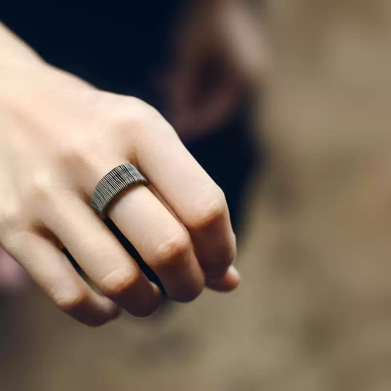 Wire-wrapped copper ring worn on the index finger